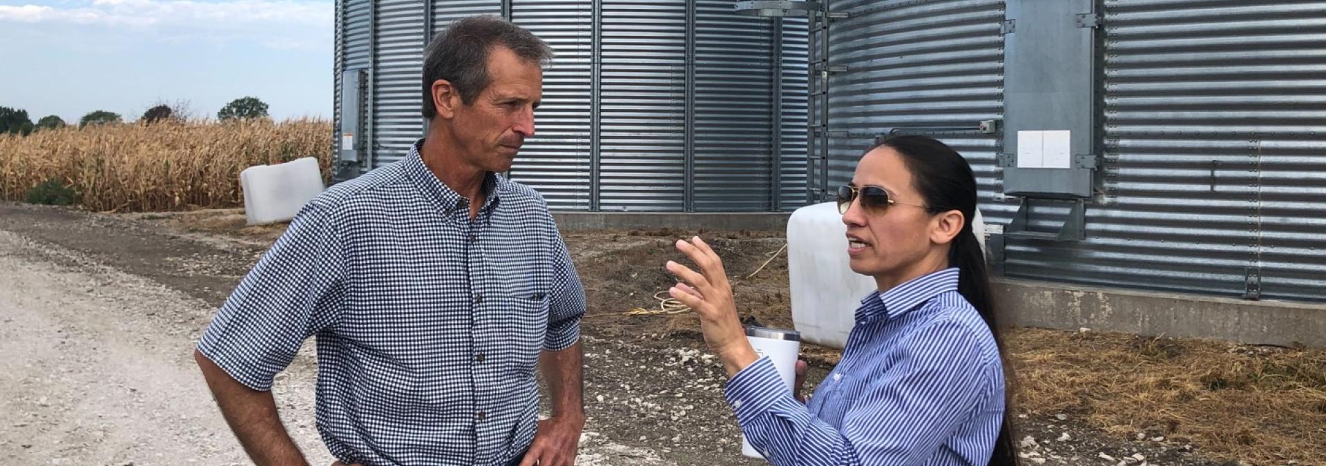 Representative Sharice Davids visits with Mike Barnes, owner of the Barnes Family Farm.