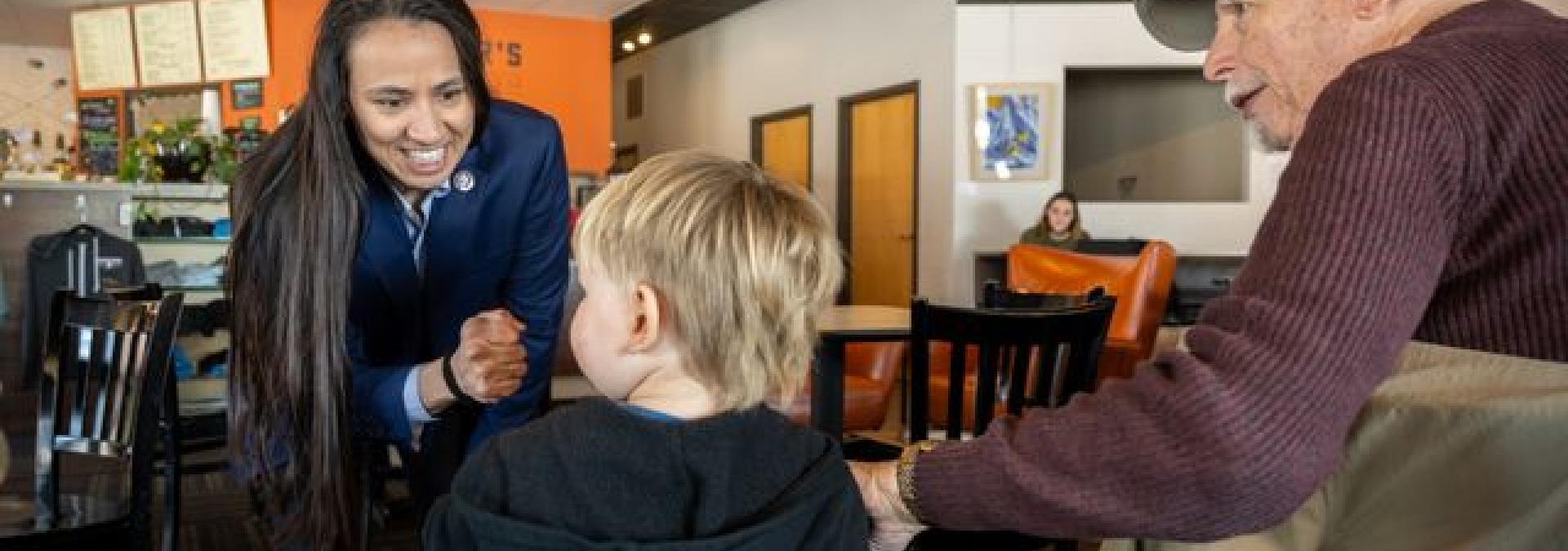 Rep. Davids interacting with a child