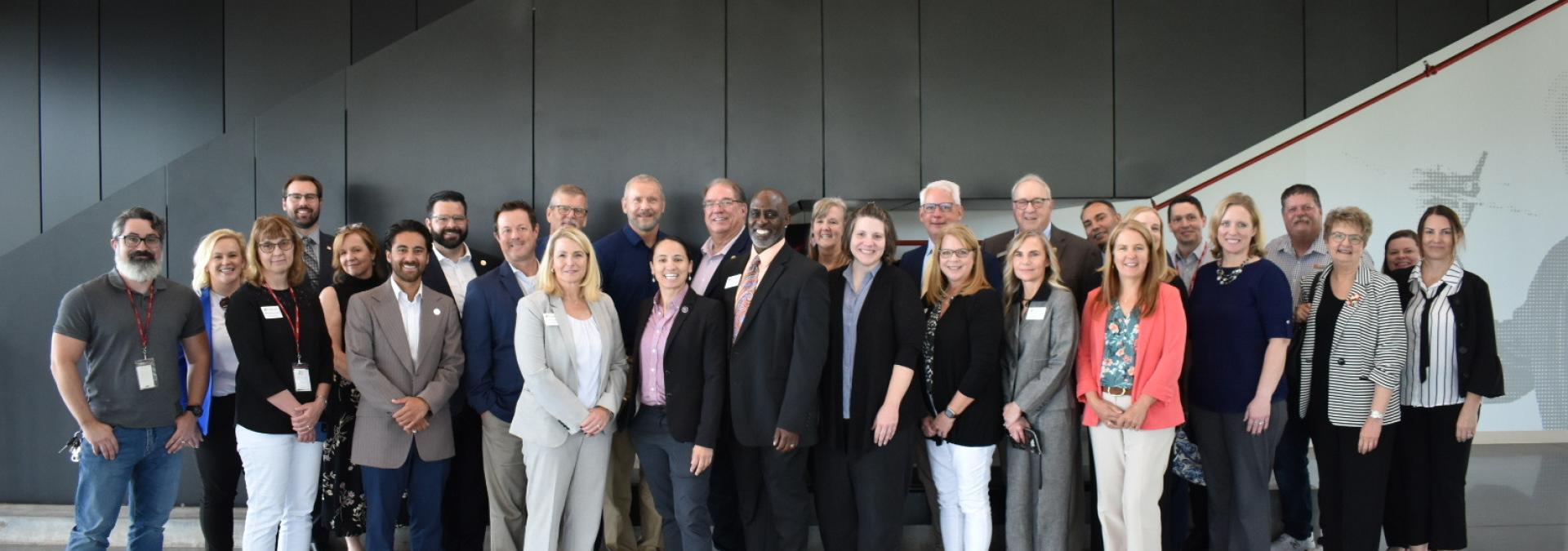 Rep. Sharice Davids with local officials celebrating the 15 projects receiving federal investments.