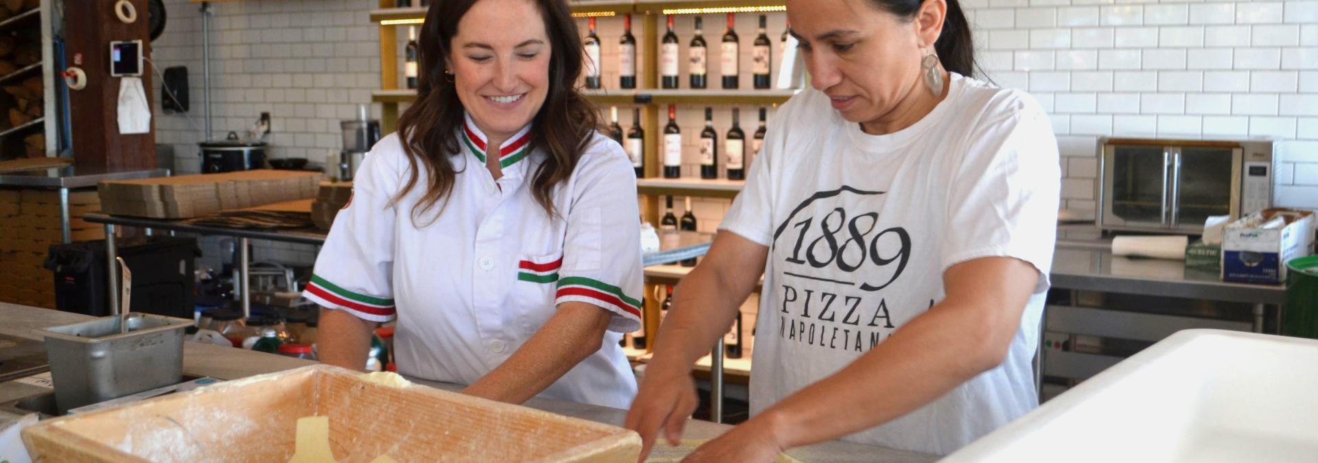 Rep. Sharice Davids working in the 1889 Pizza Napoletana kitchen.