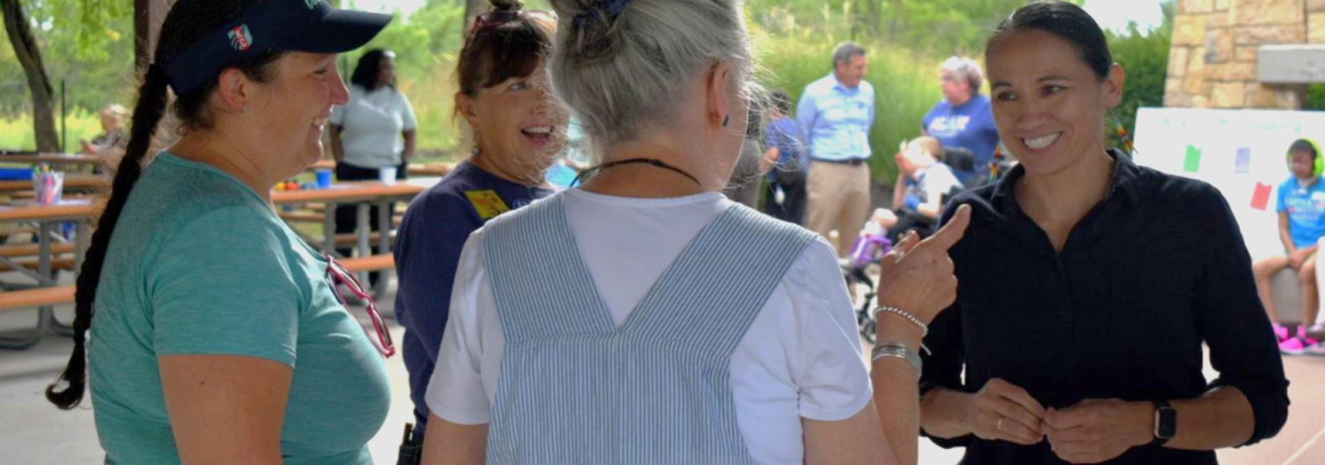 Rep. Sharice Davids and community members conversing 