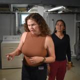 Representative Sharice Davids sees Gayle Bergman’s new energy efficient insulation, which qualified for new tax credits.