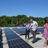 Rep. Sharice Davids with Ryan Evans of SunSmart and Sonia Garapaty of FSC, Inc. discussing recently installed solar panels.