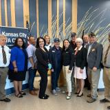 Rep. Sharice Davids with local veterans and Kansas City VA staff celebrating the one-year anniversary of the Honoring Our PACT Act at the Lenexa VA Clinic.