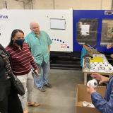Sharice Davids with mask looking at mask production facility