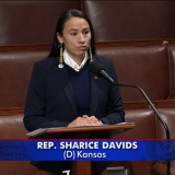 Sharice Davids at podium with microphone