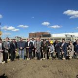 A line of people holding shovels