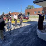 Sharice Davids standing at podium with TV cameras