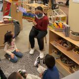 Sharice Davids reads a book to seated children