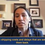 Sharice Davids sitting in front of a wall of framed pictures