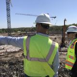 Two people in hard hats and safety vests
