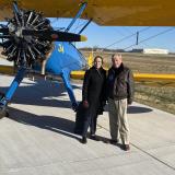 Sharice Davids stands in front of historic airplane