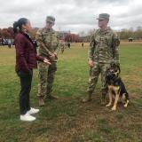 Sharice Davids with two people in army fatigues and a service dog
