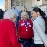 A picture of Rep. Davids listening to senior citizens in the district.