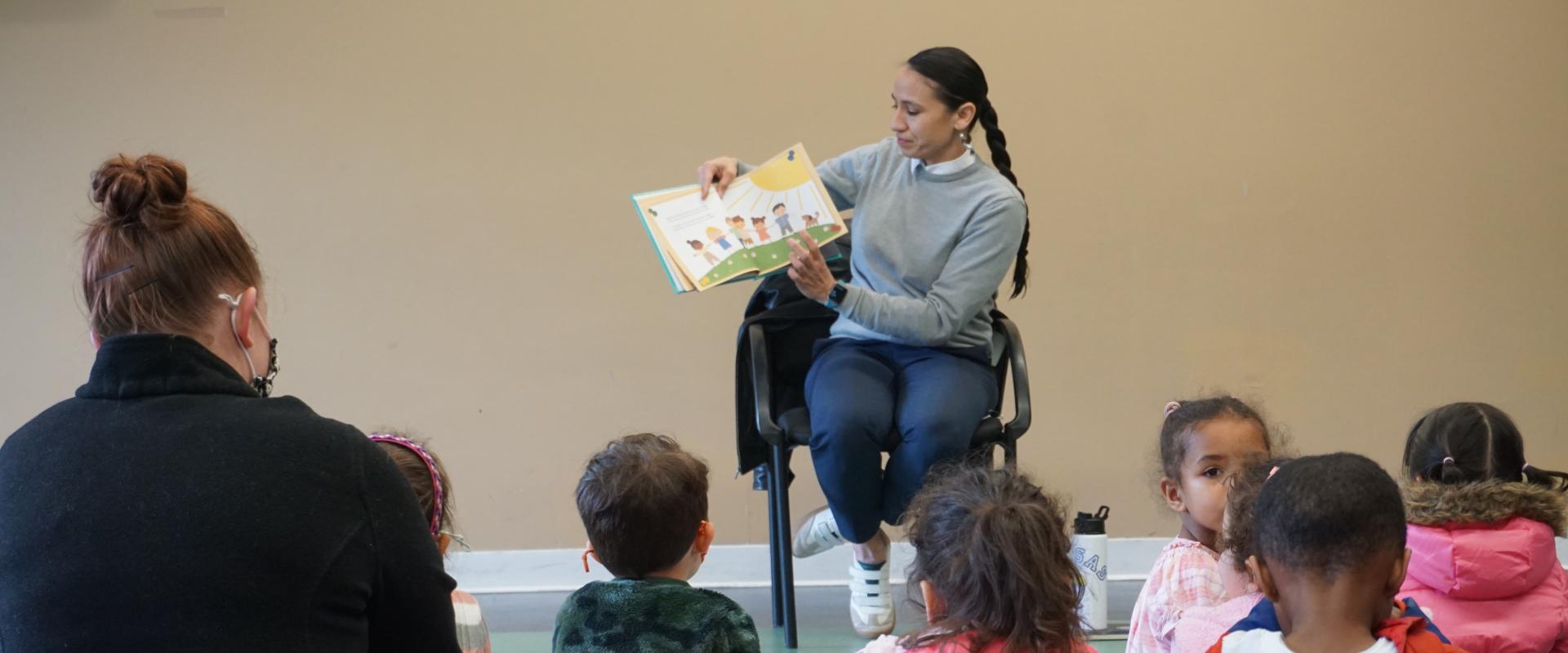 Rep. Davids reads to a group of seated children