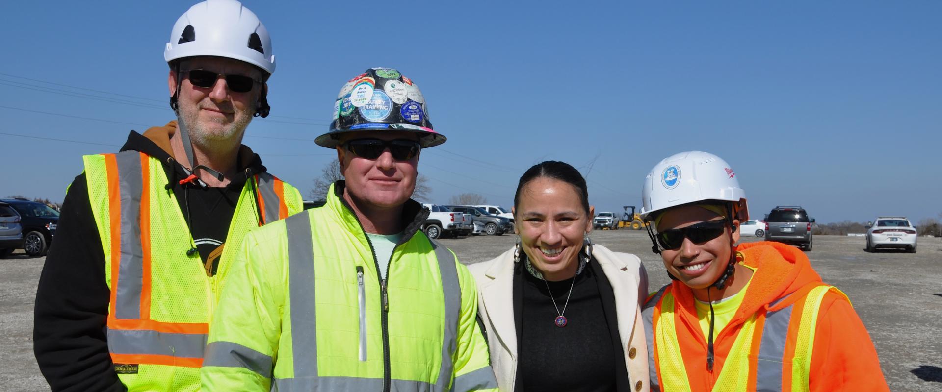 Rep. Sharice Davids with workers in hard hats and vests