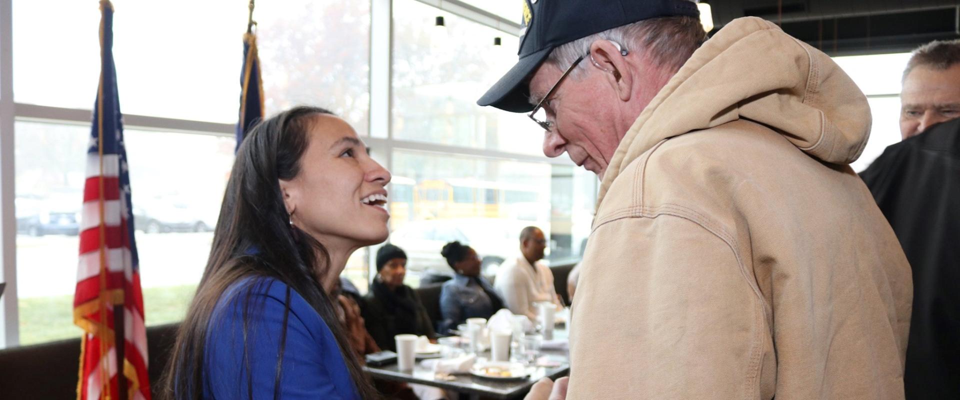 Rep. Sharice Davids shakes a constituent's hand