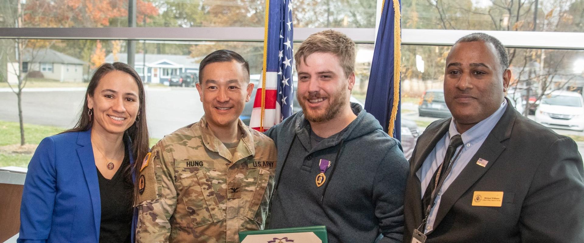 Rep. Sharice Davids stands with a group of veterans and service members.