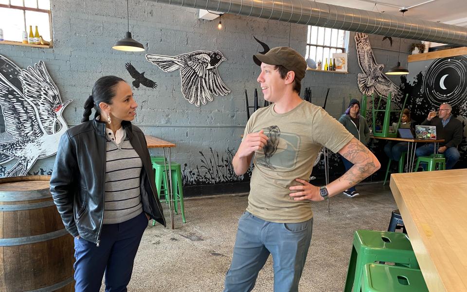 Rep. Sharice Davids speaks with a local small business owner