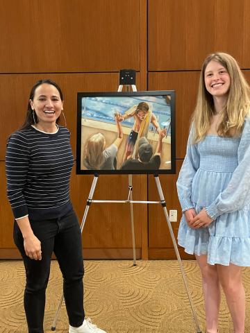 Siena Masilionis’ “A Dream Realized” – The drawing depicts a triumphant moment for Jack, a junior swimmer at Blue Valley North High School. Jack, who is Masilionis’ best friend, achieved his first-ever state qualifying cut by surpassing his personal best meet time. The artwork captures Jack celebrating his achievement by clasping his parents' hands in joy.