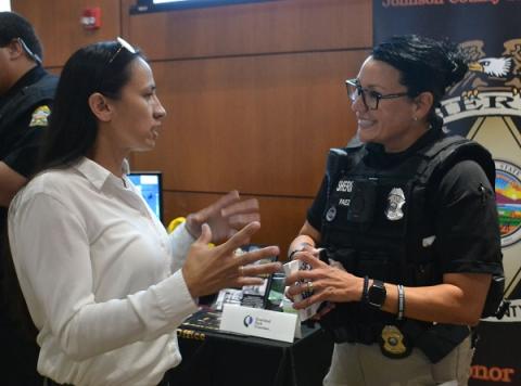 Rep. Davids speaking with a law enforcement officer.