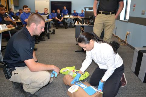 Representative Sharice Davids learns CPR techniques with Johnson County Regional Police Academy recruits.