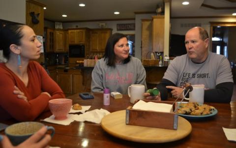 Rep. Davids listening to Kansas Third District constituents at their kitchen table.