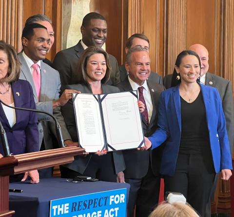 Rep. Sharice Davids at the signing of the bipartisan Respect for Marriage Act.