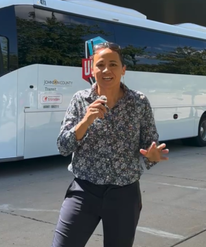 Davids speaking in front of bus