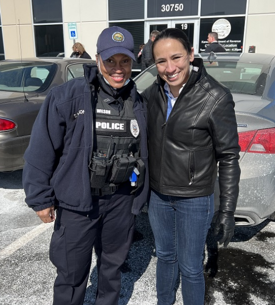 Rep. Sharice Davids with a local police officer at Johnson County Community College.