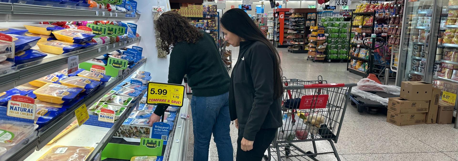 Representative Sharice Davids grocery shopping with a constituent.