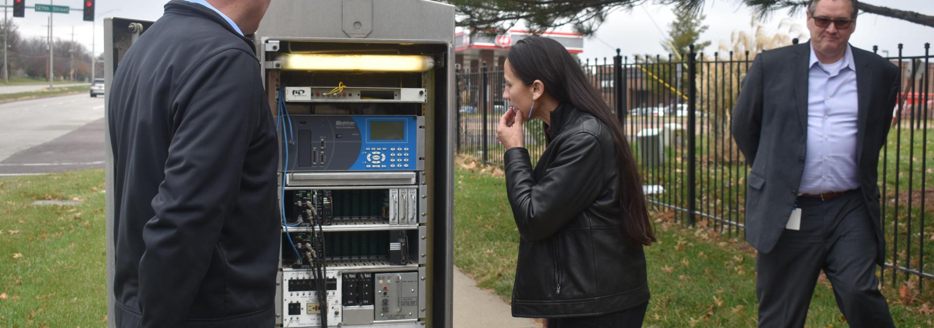 City Traffic Engineer Brian Shields showing Rep. Sharice Davids an outdated traffic control signal.