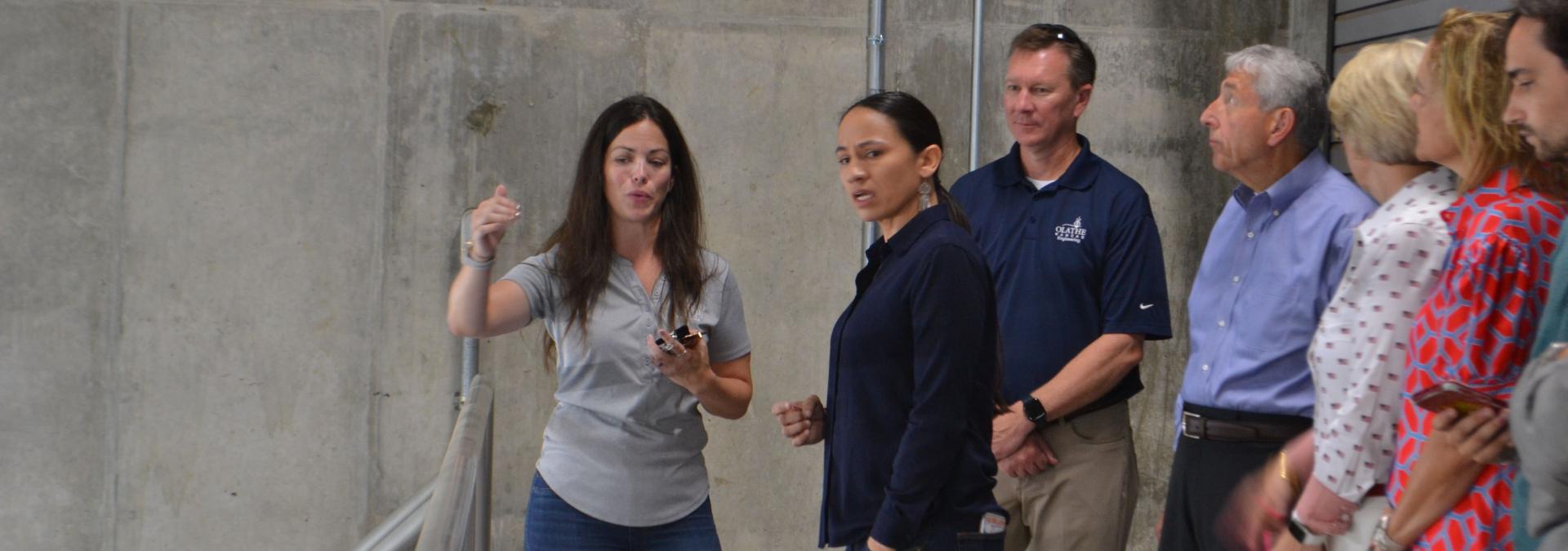 Nicole Woods, a City of Olathe engineering project manager, gives Rep. Sharice Davids a tour of the Renner Pump Station.