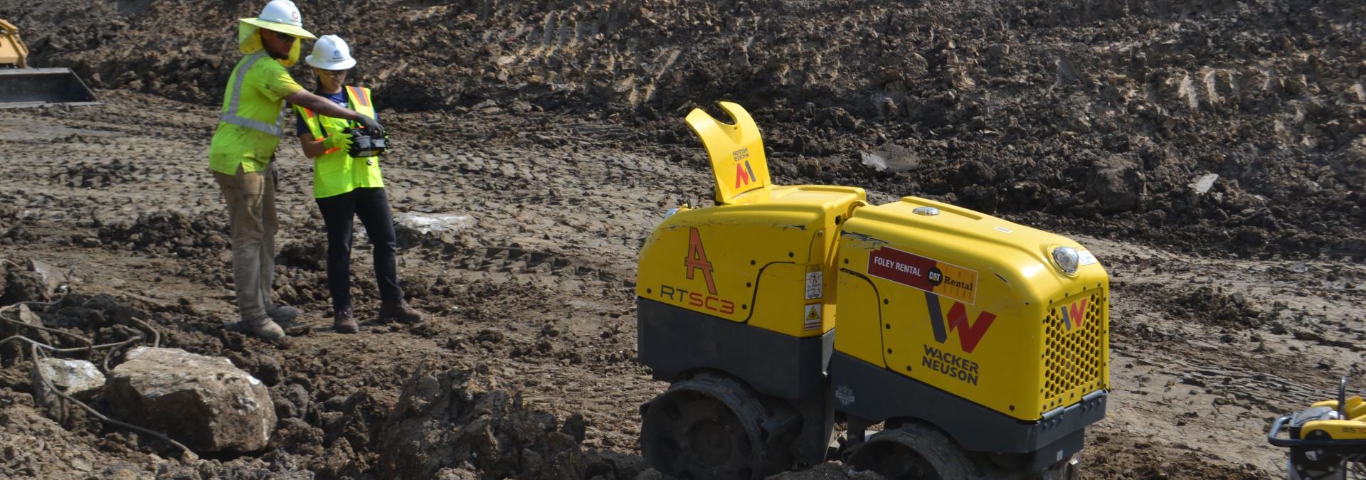 Rep. Sharice Davids operating the remote control trench compactor to prepare for construction on the US 69 expansion project.