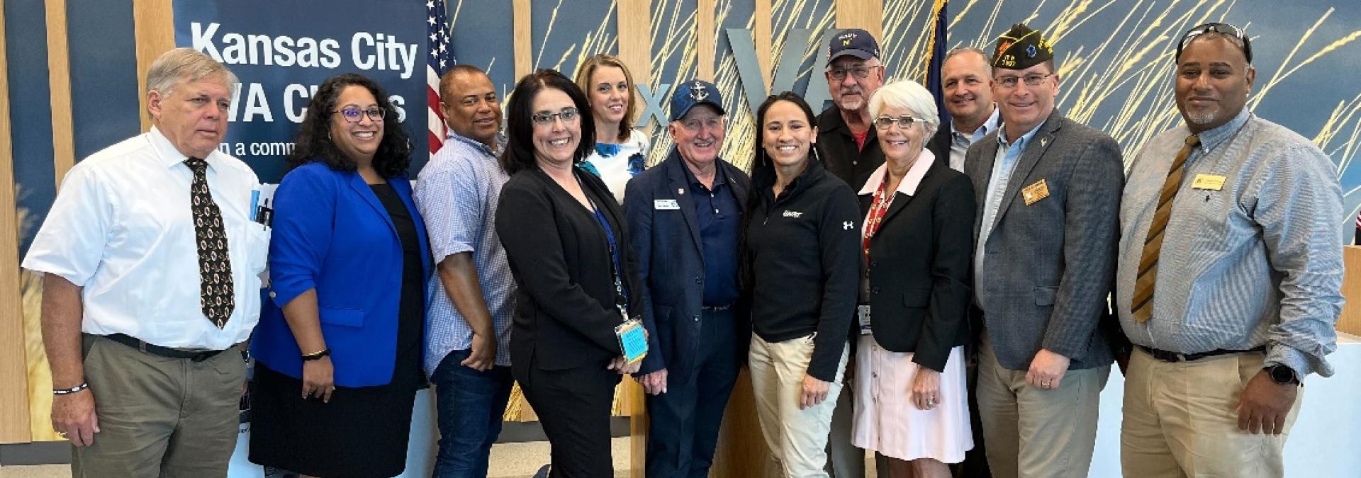 Rep. Sharice Davids with local veterans and Kansas City VA staff celebrating the one-year anniversary of the Honoring Our PACT Act at the Lenexa VA Clinic.