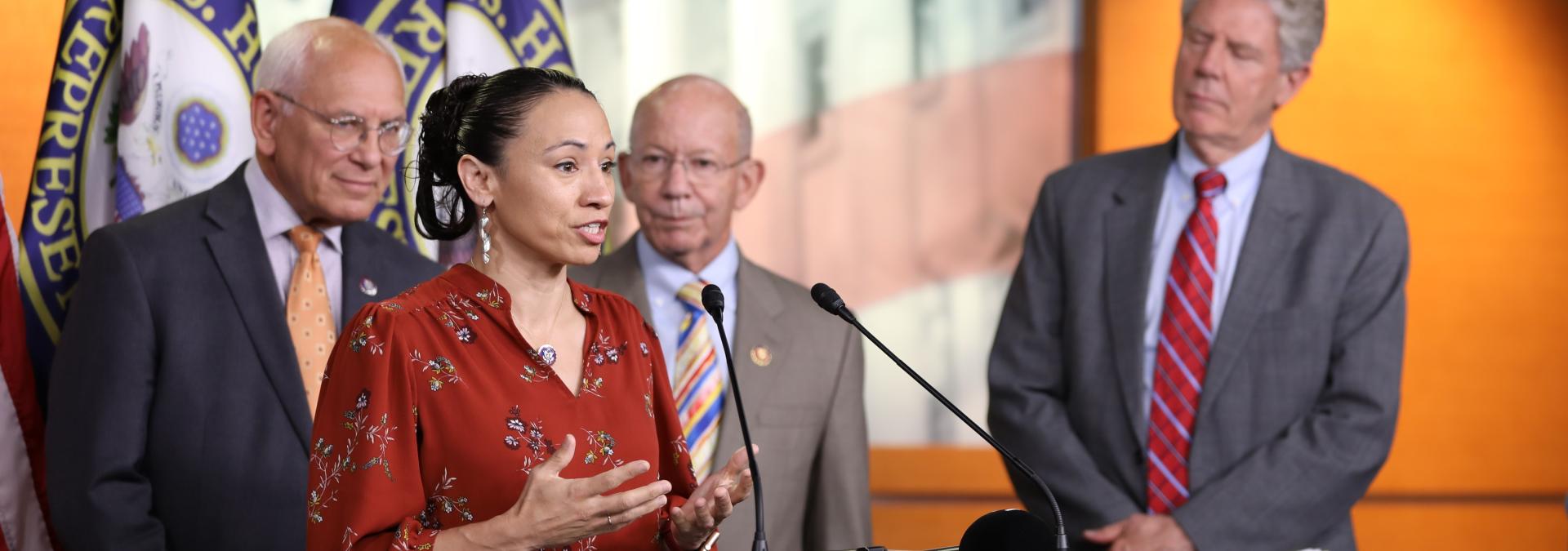 Congresswoman Davids Speaks at a Podium