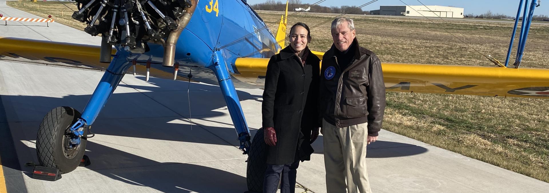 Sharice Davids stands in front of historic airplane