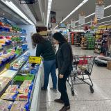 Representative Sharice Davids grocery shopping with a constituent.