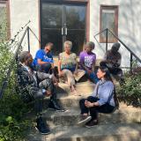 Representatives Cleaver and Davids speaking with the Webb family on the steps of the former Walker School. 