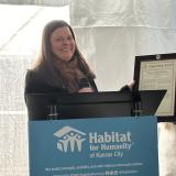 Rep. Sharice Davids’ District Director, Anne Hucker, presents Lindsay Hicks with an official congratulatory statement submitted to the Congressional Record.