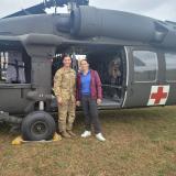 Rep. Davids with a servicemember in uniform in front of a helicopter