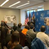 Congresswoman Davids Speaks at a Podium in front of a seated audience