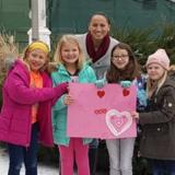 Rep. Davids with young children holding a Valentine's Day poster