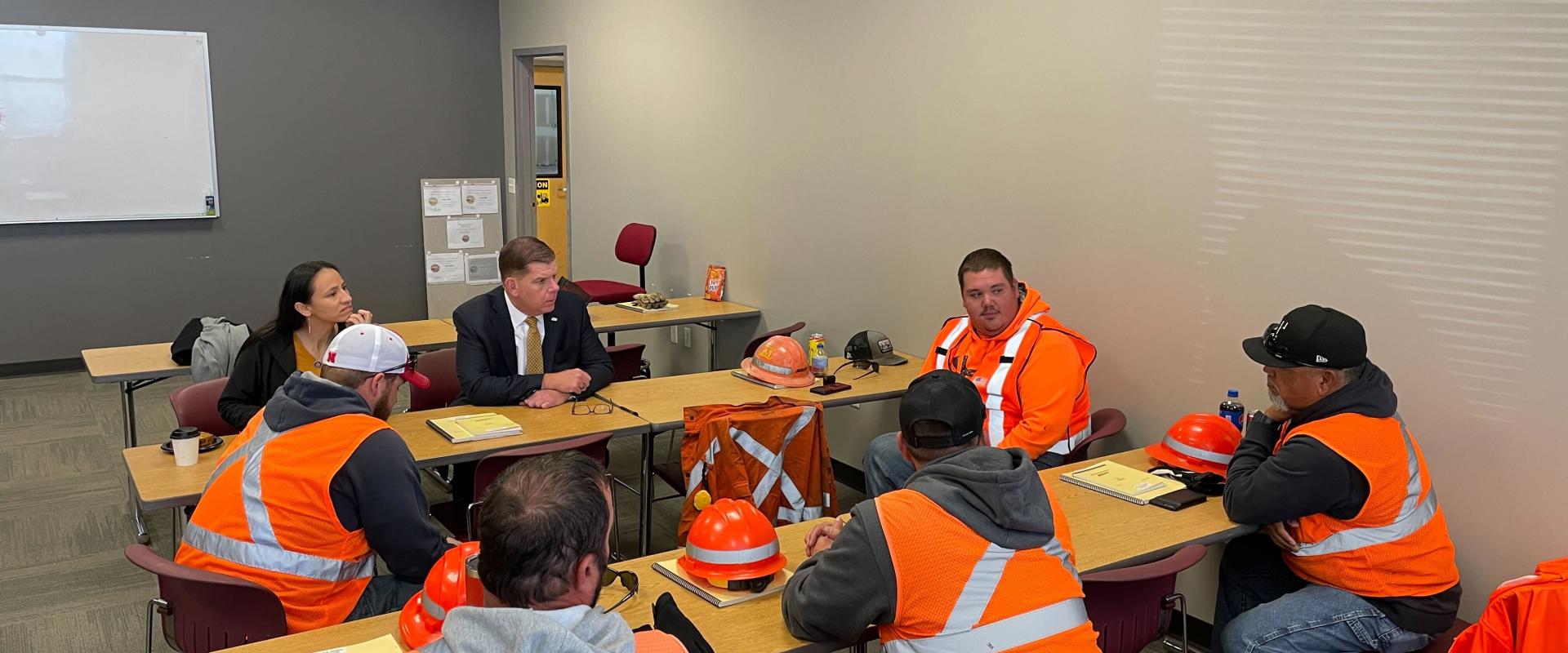 Rep. Davids and US Labor Secretary Marty Walsh speaking with drivers in the JCCC CDL program.
